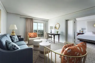 a hotel room with a king bed and a living room at The Ritz-Carlton, Marina del Rey in Los Angeles