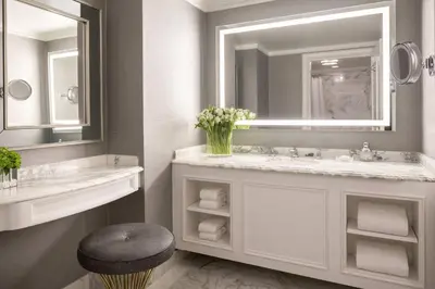 a bathroom with a sink and a mirror and a stool at The Ritz-Carlton, Marina del Rey in Los Angeles