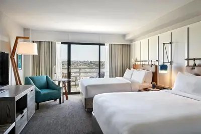 a hotel room with two beds and a television at Westdrift Manhattan Beach, Autograph Collection in Manhattan Beach