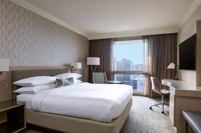a hotel room with a large bed and a large window at Los Angeles Airport Marriott in Los Angeles