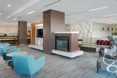 a living room with a fireplace and a couch and chairs at Residence Inn Long Beach Downtown in Long Beach