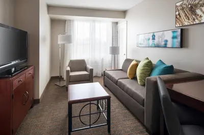 a living room with a couch and a tv at Residence Inn Long Beach Downtown in Long Beach