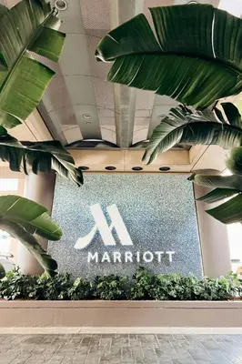 a marriot sign in a building with plants at Marriott Long Beach Downtown in Long Beach