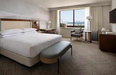 a hotel room with a bed and a large window at Marriott Long Beach Downtown in Long Beach
