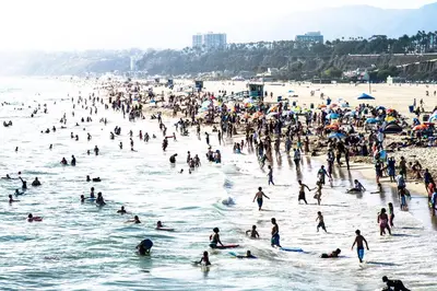a large group of people in the water at the beach at Ocean Park Hotel in Los Angeles