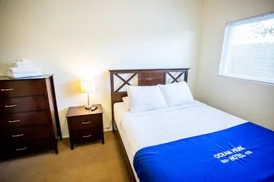 a small bedroom with a bed and a dresser at Ocean Park Hotel in Los Angeles