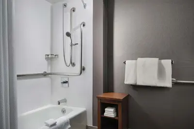 a bathroom with a shower and a sink and towels at Courtyard Los Angeles Century City/Beverly Hills in Los Angeles