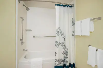 a bathroom with a shower curtain and a bath tub at Residence Inn Bakersfield in Bakersfield