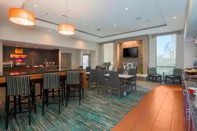 a hotel room with a bar and a dining room at Residence Inn Bakersfield in Bakersfield
