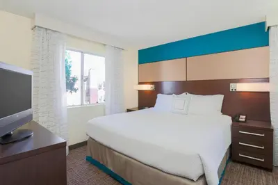 a bedroom with a bed and a flat screen tv at Residence Inn Bakersfield in Bakersfield