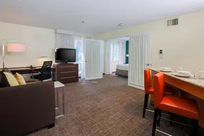 a living room with a room with a bed and a desk at Residence Inn Bakersfield in Bakersfield