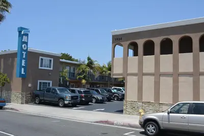 a parking lot with cars parked in front of a hotel at Seaside Motel in Redondo Beach