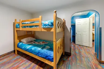 a bedroom with two bunk beds and a mirror at Anaheim Discovery Inn and Suites in Anaheim