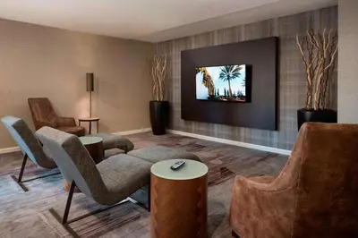 a living room with chairs and a couch at Sonesta Select Los Angeles Torrance South Bay in Torrance