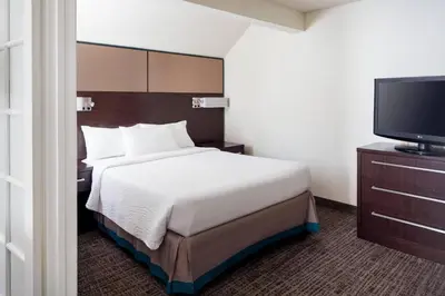 a hotel room with a bed and a flat screen tv at Residence Inn Los Angeles Torrance/Redondo Beach in Torrance
