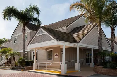 a house with palm trees in front of it at Residence Inn Los Angeles Torrance/Redondo Beach in Torrance