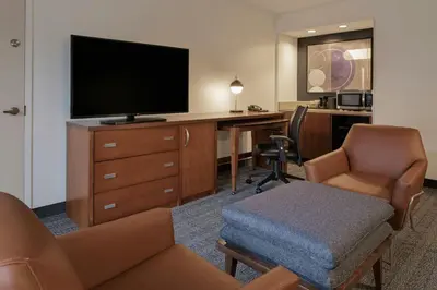 a hotel room with a desk and a television at Courtyard Anaheim Buena Park in Buena Park