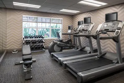 a fitness room with treadmills and cardio machines at Residence Inn by Marriott Cypress Los Alamitos in Los Alamitos