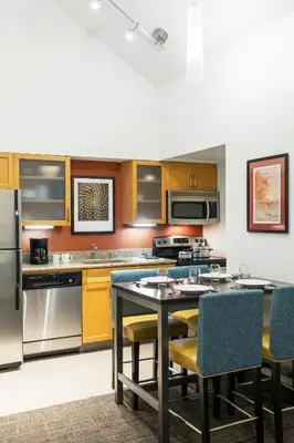 a kitchen with a table and chairs in it at Residence Inn Anaheim Placentia/Fullerton in Placentia