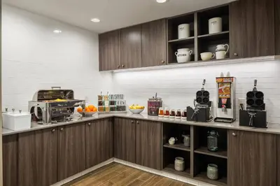 a kitchen with wooden cabinets and a counter top at Residence Inn Pasadena Arcadia in Arcadia