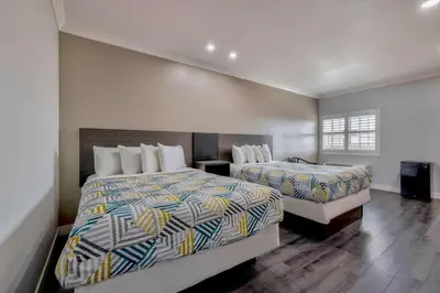 a hotel room with two beds and a window at Motel 6 South Gate CA in South Gate