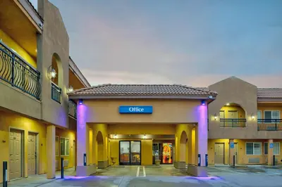 a hotel building with a sign that reads office at Motel 6 South Gate CA in South Gate