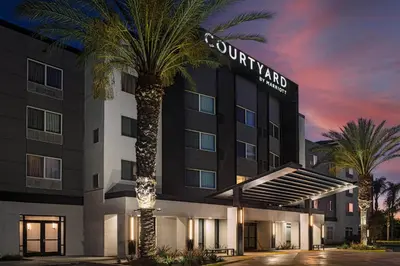 a hotel with palm trees in front of a building at Courtyard by Marriott Anaheim Resort/Convention Center in Anaheim