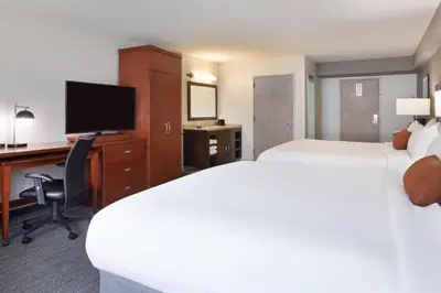 a hotel room with two beds and a desk and a computer at Courtyard by Marriott Los Angeles LAX / Century Boulevard in Los Angeles