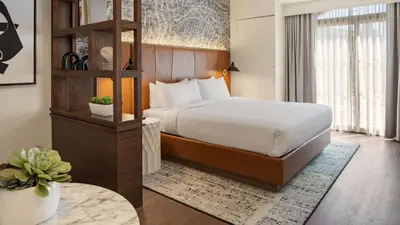 a hotel room with a bed and a table at Burton House, Beverly Hills, A Tribute Portfolio Hotel in Los Angeles