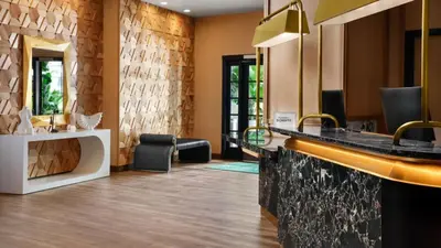 a bathroom with a sink and a mirror at Burton House, Beverly Hills, A Tribute Portfolio Hotel in Los Angeles