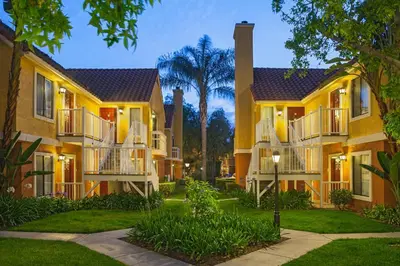 a row of houses with balconies and trees at Clementine Hotel & Suites Anaheim in Anaheim
