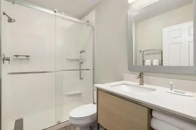 a bathroom with a shower and a toilet and a sink at TownePlace Suites by Marriott Anaheim Maingate Near Angel Stadium in Anaheim