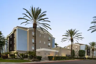 a hotel with palm trees in front of a building at TownePlace Suites by Marriott Anaheim Maingate Near Angel Stadium in Anaheim