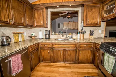 a kitchen with wooden cabinets and a sink at Majestic Pines Home in Big Bear Lake
