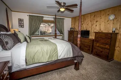 a bedroom with a bed and a ceiling fan at Majestic Pines Home in Big Bear Lake