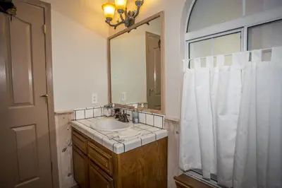 a bathroom with a sink and a mirror at Majestic Pines Home in Big Bear Lake