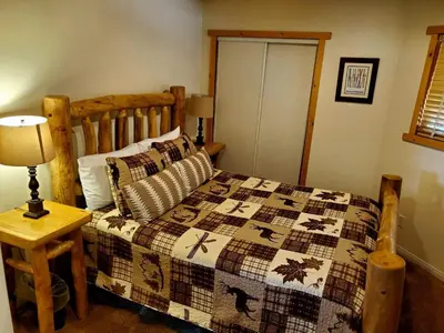 a bedroom with a bed with a quilt on it at Big Bear Splash Home in Big Bear Lake
