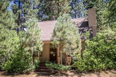 a small house with trees in front of it at Mountain Air Home in Big Bear Lake