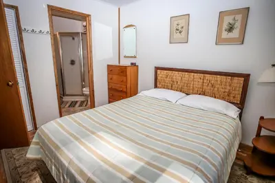 a bedroom with a bed with a striped comforter at Mountain Air Home in Big Bear Lake