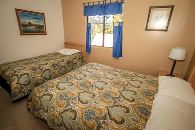 a bedroom with two beds and a window at Family Fun House in Big Bear Lake