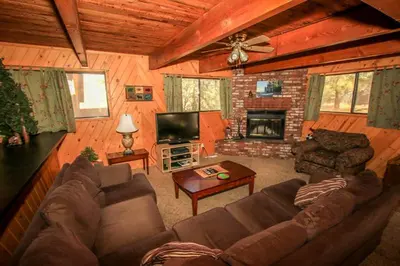 a living room with a couch and a fireplace at Family Fun House in Big Bear Lake