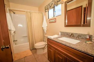 a bathroom with a sink and a toilet and a shower at Family Fun House in Big Bear Lake