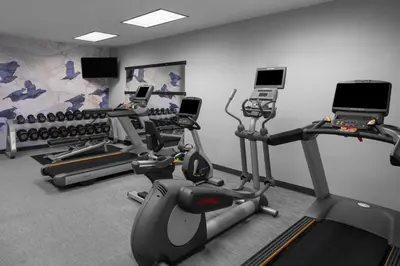 a gym with several treadmills and cardio machines at Courtyard by Marriott Santa Clarita Valencia in Valencia