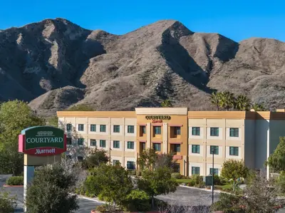 a hotel with mountains in the background at Courtyard by Marriott Santa Clarita Valencia in Valencia