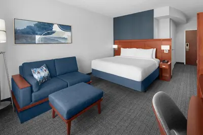 a hotel room with a bed and a couch at Courtyard by Marriott Santa Clarita Valencia in Valencia