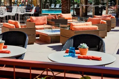 a patio with tables and chairs and a pool at Los Angeles Marriott Burbank Airport in Burbank