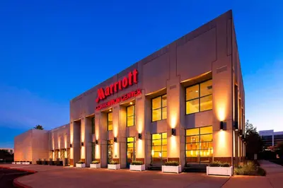 a large building with a red sign on it at Los Angeles Marriott Burbank Airport in Burbank