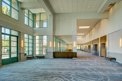 an empty hallway in a building with windows at Los Angeles Marriott Burbank Airport in Burbank