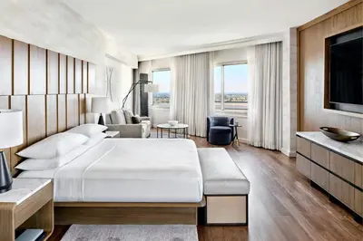 a hotel room with a large bed and a couch at Anaheim Marriott in Anaheim