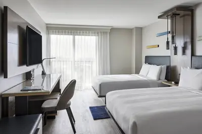 a hotel room with two beds and a television at Anaheim Marriott in Anaheim